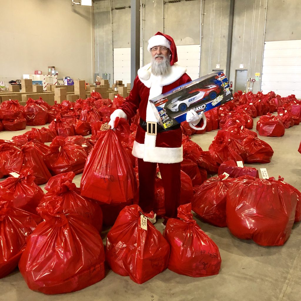 Santa Claus at Sherwood Ford distributing toy donations