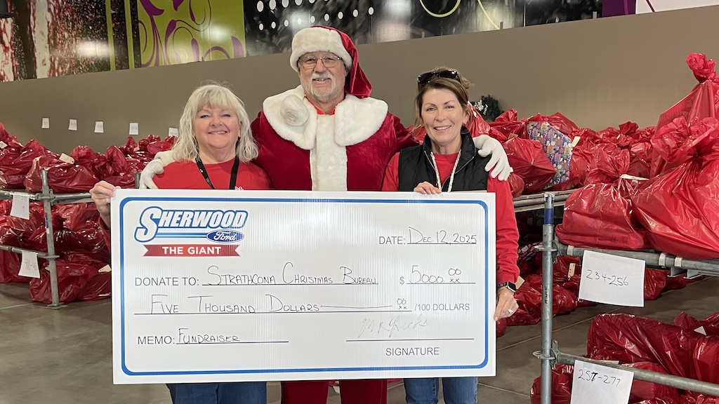 Sherwood Ford Santa with donation for the Strathcona Christmas Bureau