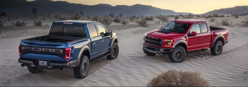 Two different 2019 Ford F-150s face each other in a desert.