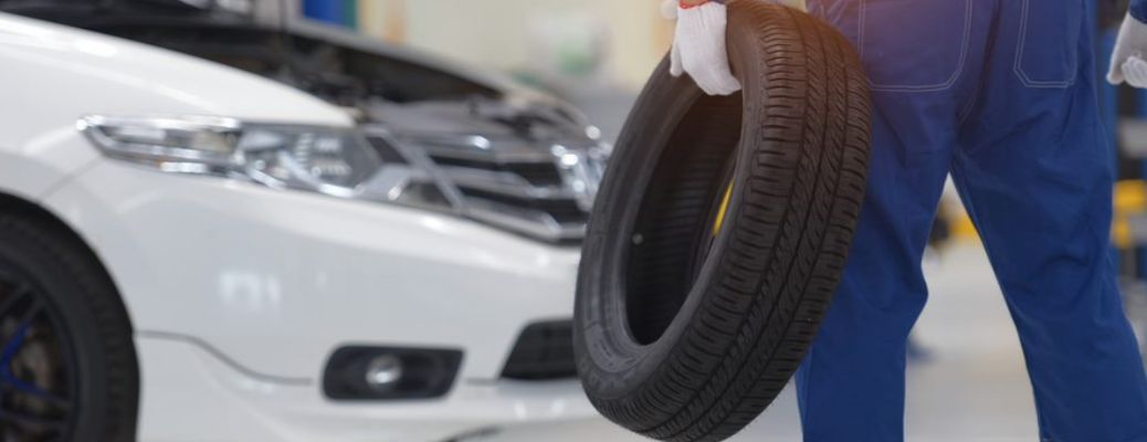 Service technician holding a tire