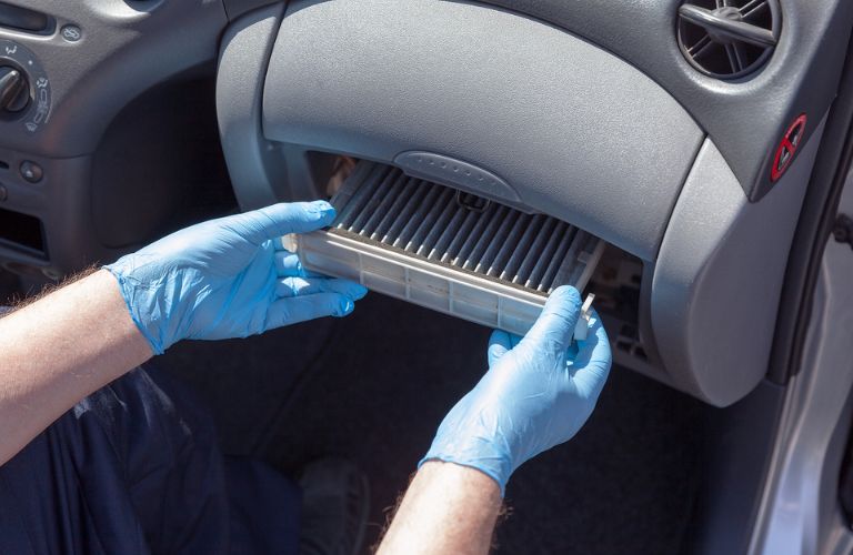 Technician taking out an old air filter