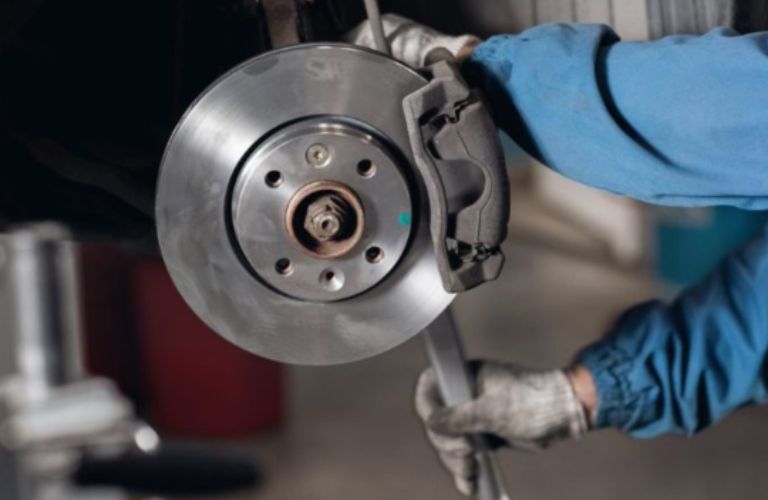 Mechanic inspecting a vehicle's brake plate