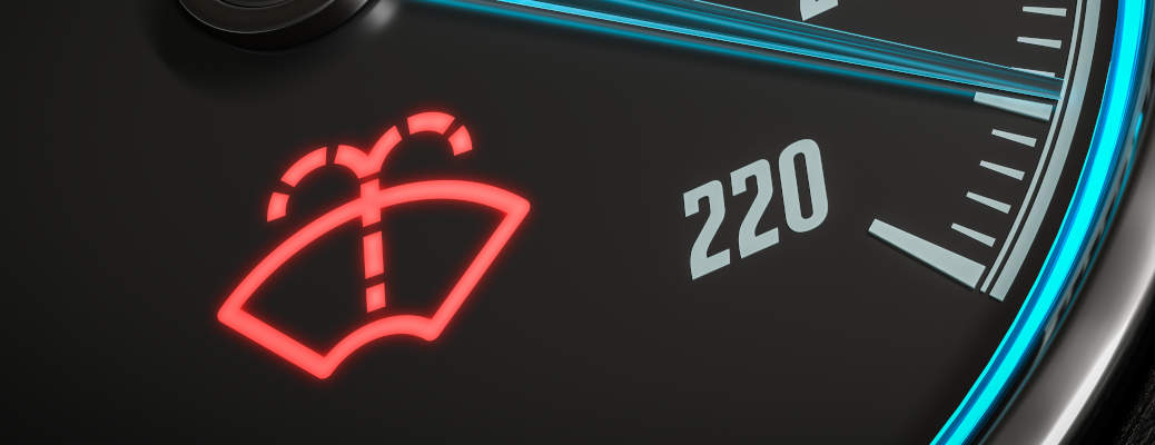 Low windshield washer fluid indicator warning in car dashboard