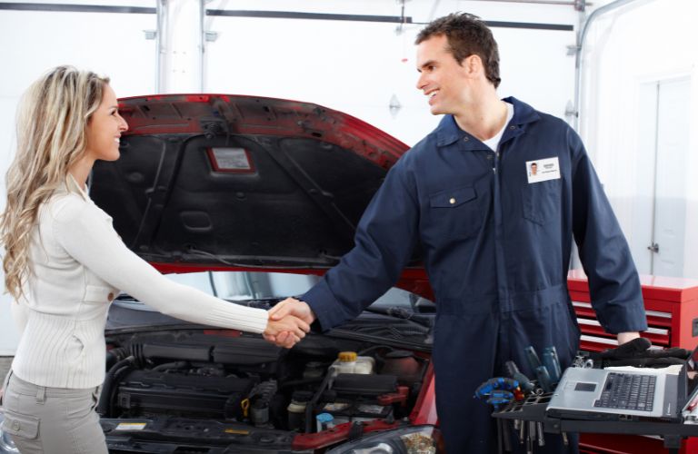 A mechanic shaking hands with a customer