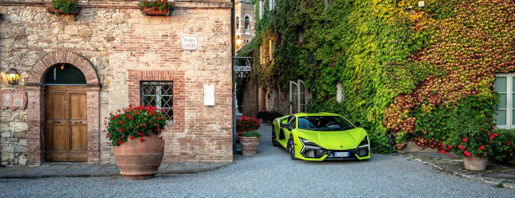 A Lamborghini Revuelto on tour of Tuscany near a castle