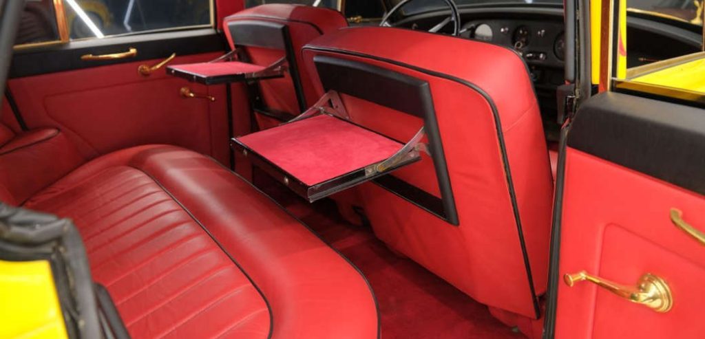 The rear seating with fold-down tray tables in the 1960 Silver Cloud II for sale at Limited Spec in Miami
