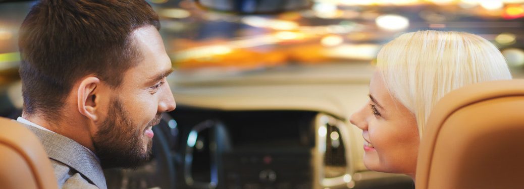 couple in a car staring lovingly into one another's eyes while on the road