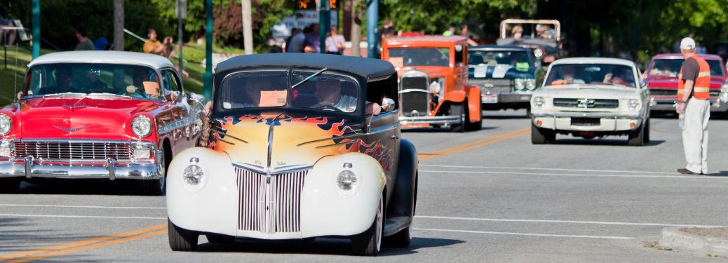 classic American cars driving down the road