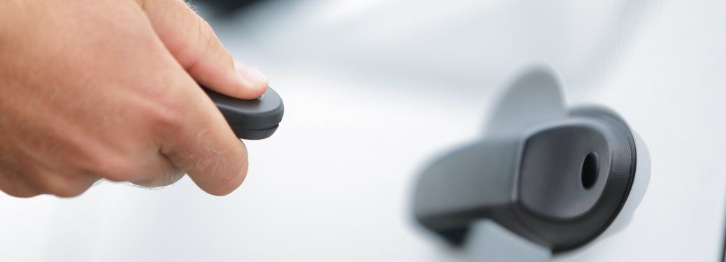 person unlocking their vehicle with a keyfob