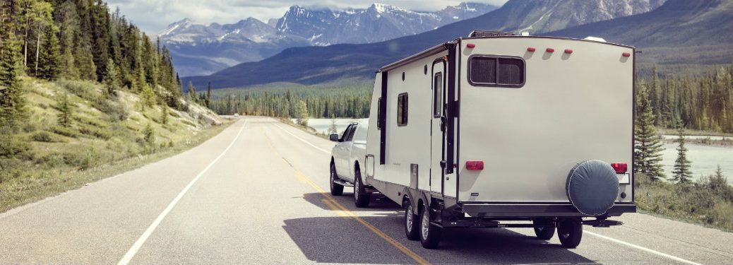 truck pulling a trailer through mountains