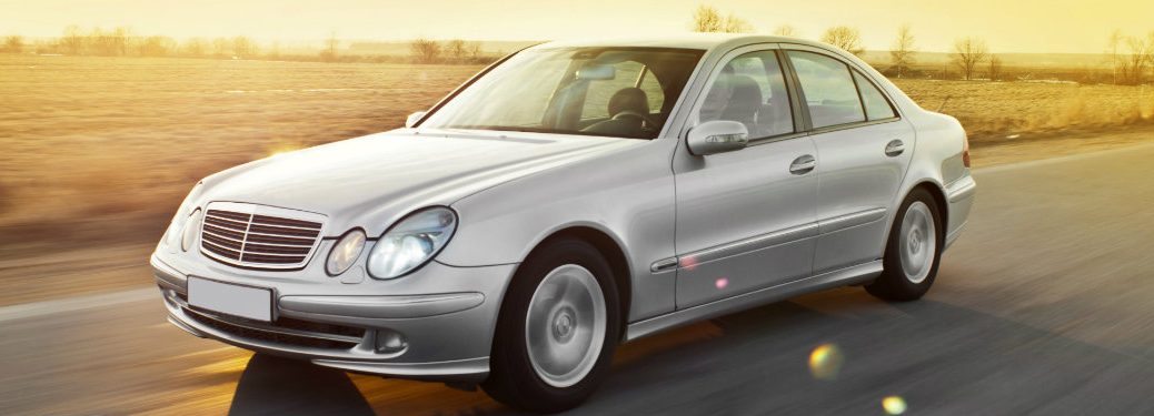 generic silver sedan driving on the road in the summer