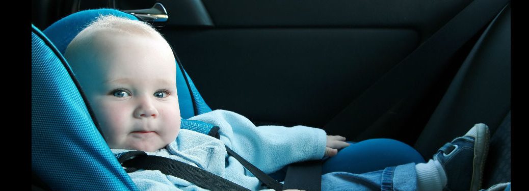 baby in a rear-facing car seat looking at the camera