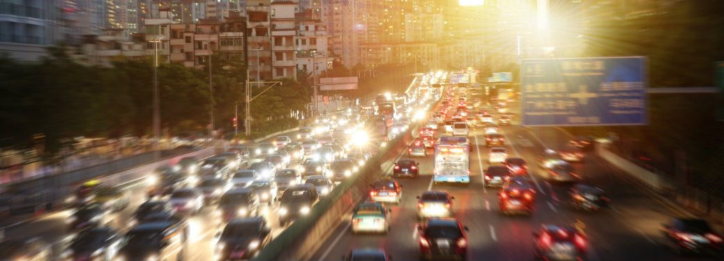 cars driving on a city highway in the evening