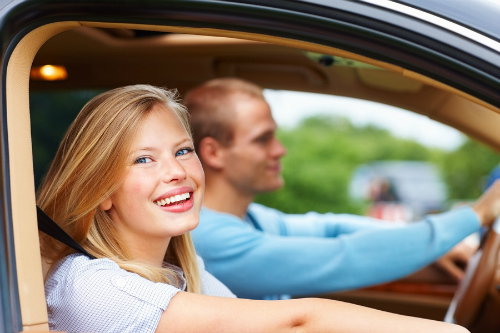 Happy people driving with windows open