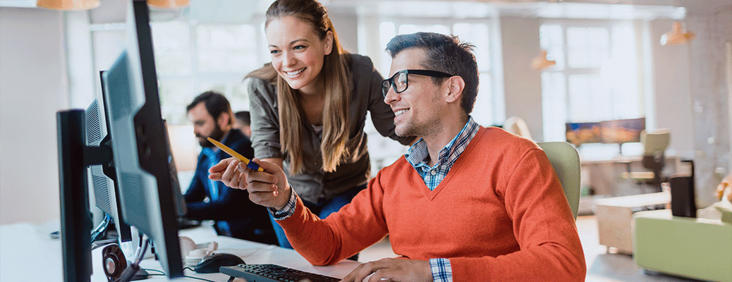 two people looking at a computer together