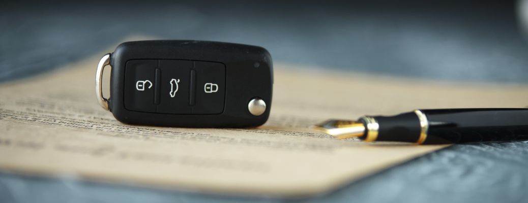 key and pen on a document