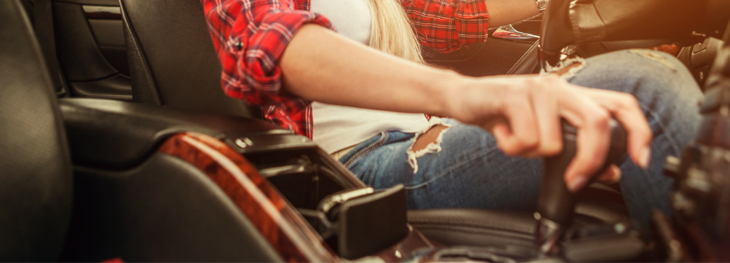 A woman switching gear while driving a vehicle