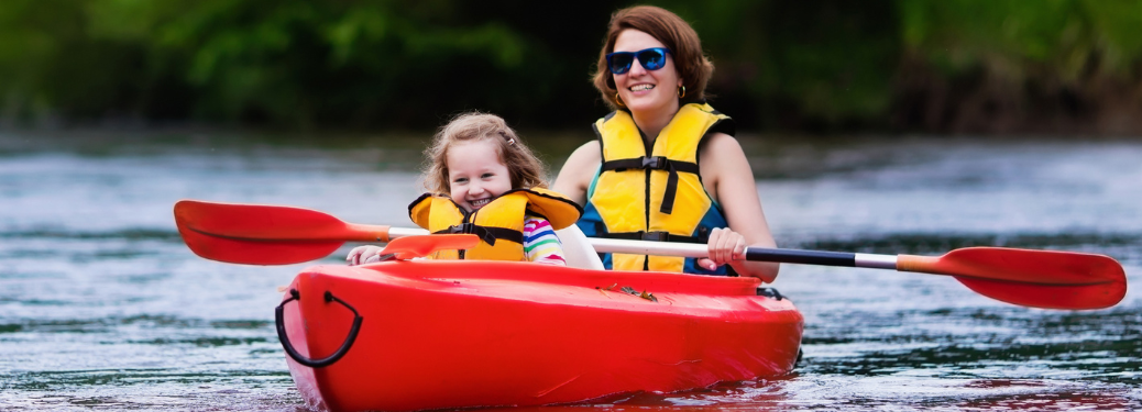 Mother and daughter paddling in kayak