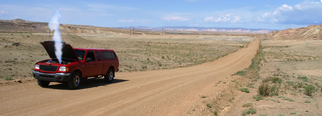 An overheated car stranded on the road