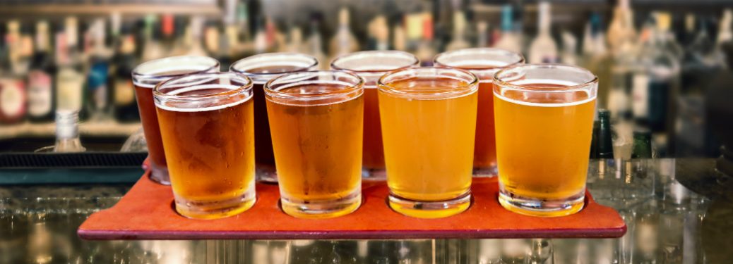 An assortment of beers sitting on a bar