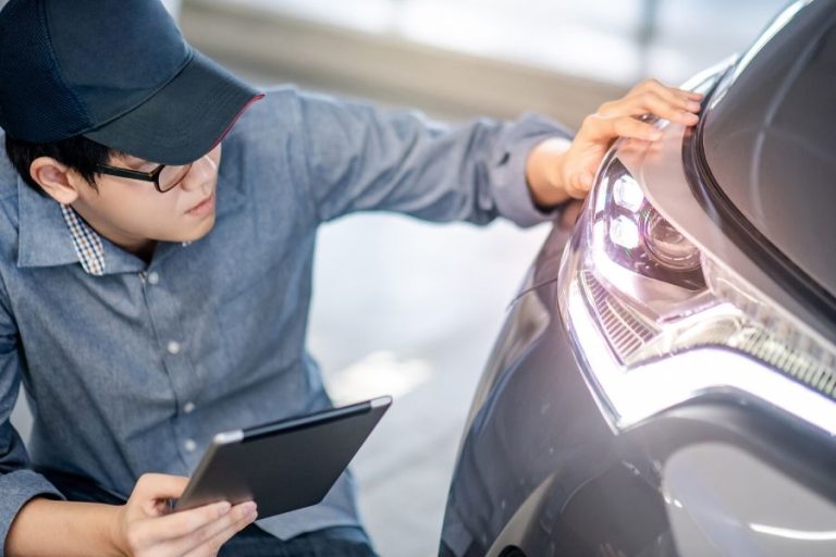 Man examining headlight