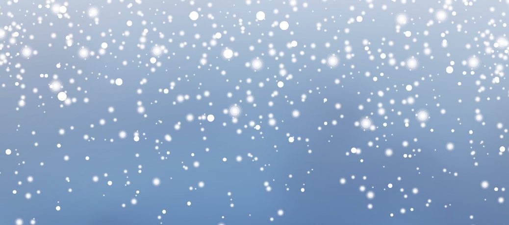 Falling snow against a blue sky.