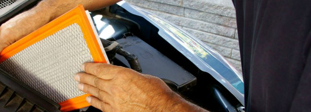 man changing cabin air filter