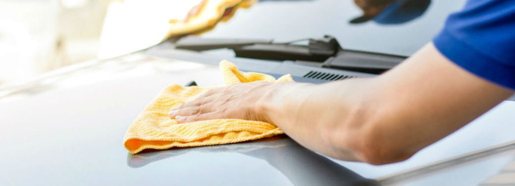 person cleaning rust off a vehicle