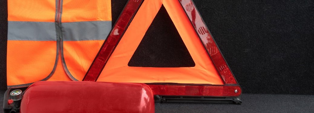 orange vest reflective triangle and fire extinguisher