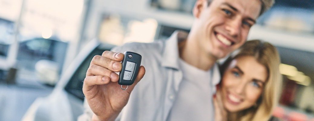 A stock photo of a couple holding a new set of keys.