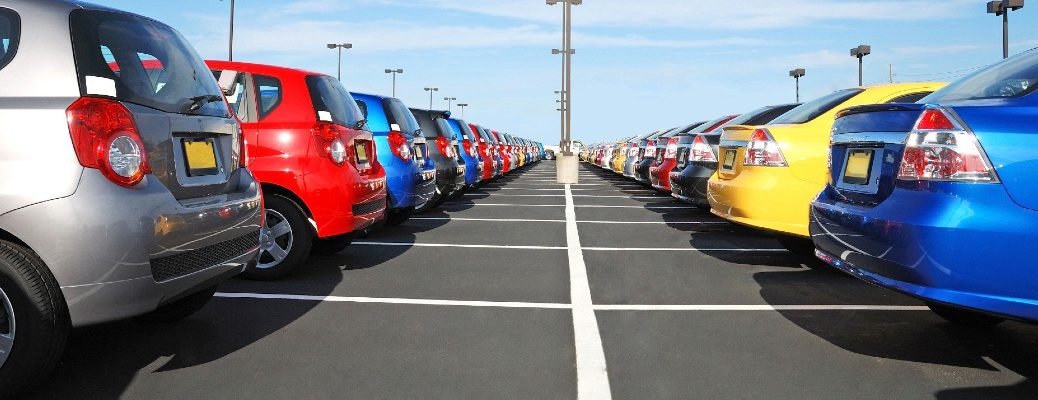 A stock photo of a vehicles lined up at a dealership.