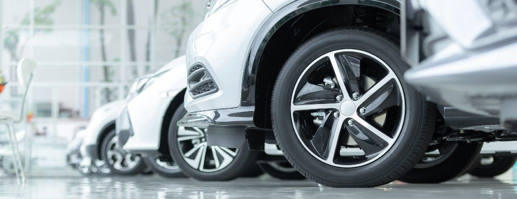 A stock photo of cars in a dealership's showroom.