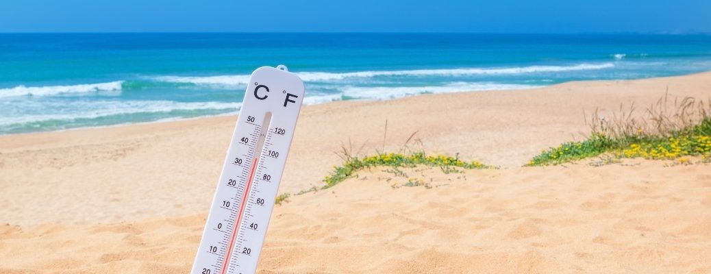 A stock photo of a thermometer at a beach.