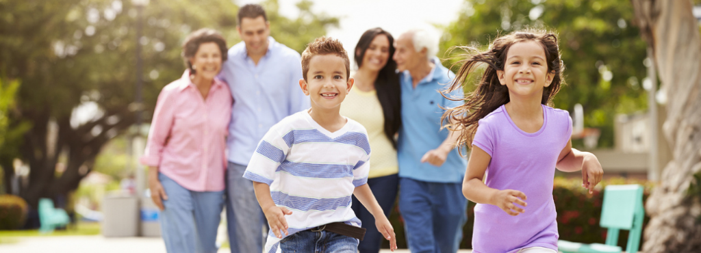 A Family enjoying in a park and kids running happily in front