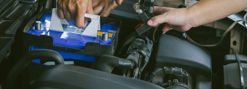 A technician placing a new battery into the slot