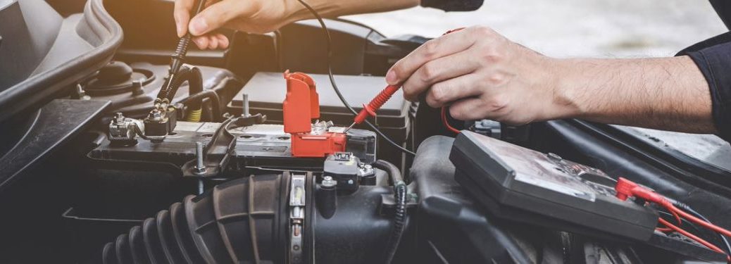 An image of the a mechanic repairing the car engine
