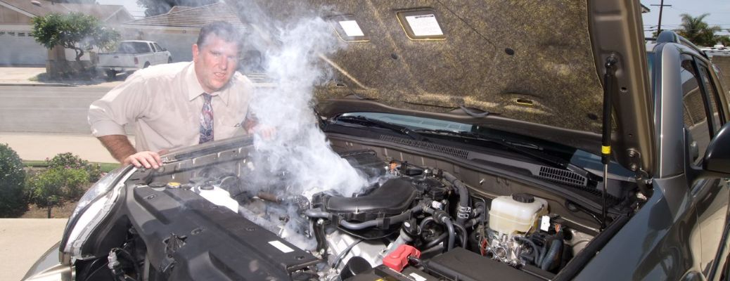 Man near a car that is overheated