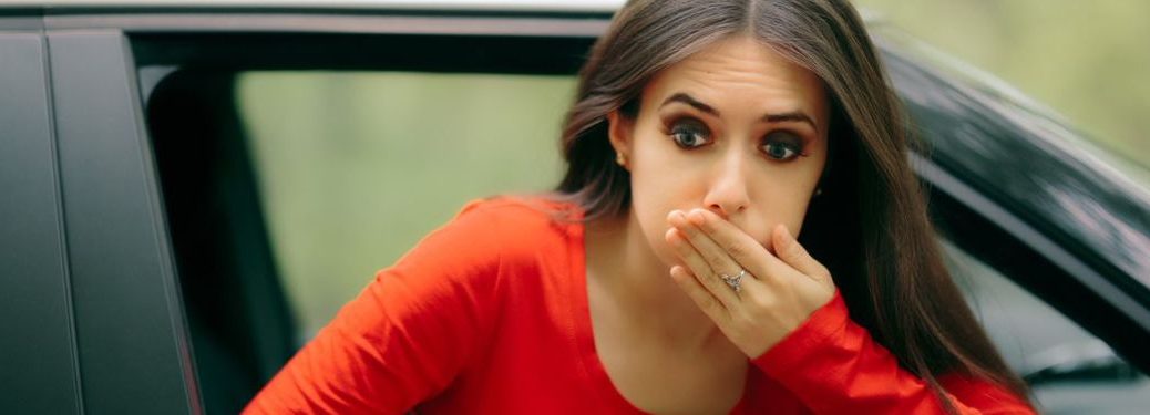 A lady in red is feeling nauseaus