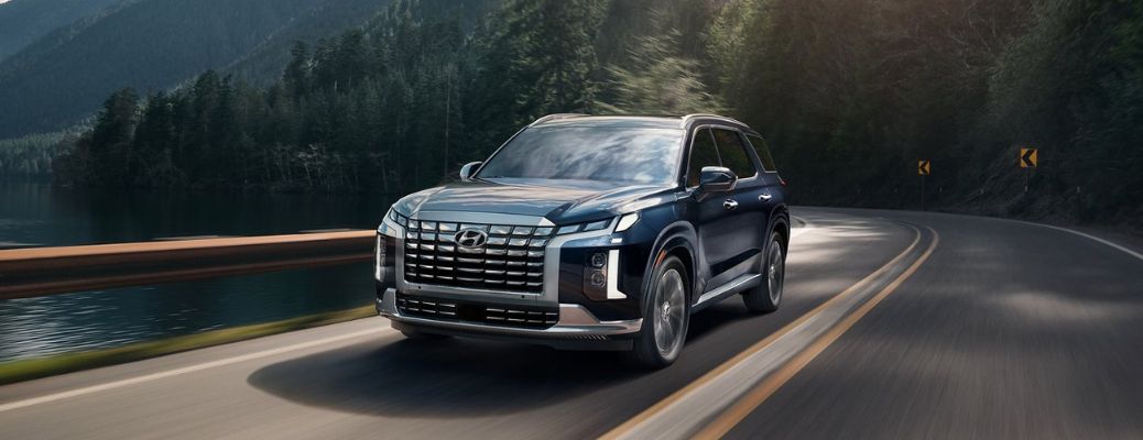 A 2023 Hyundai Palisade on a smooth mountain pass road