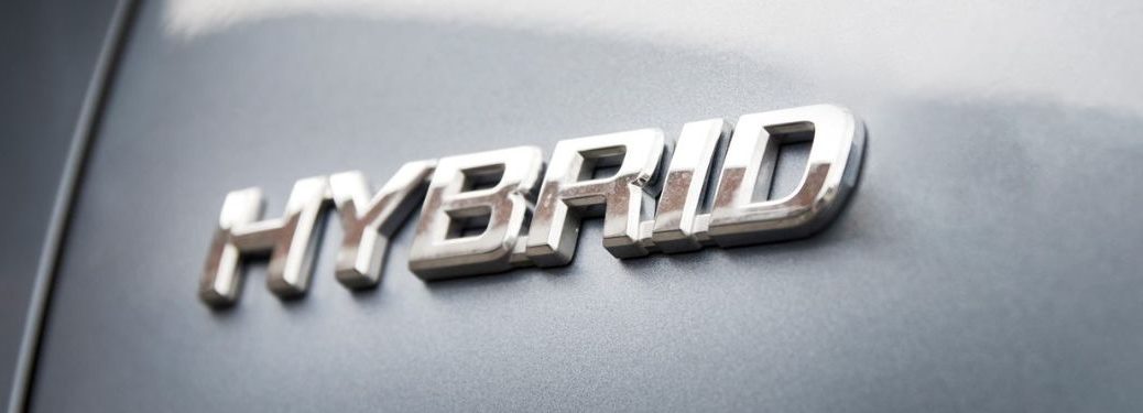 Hybrid is written on a grey coloured car.