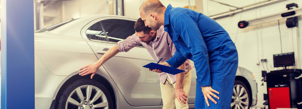 Mechanic and customer at a dealership