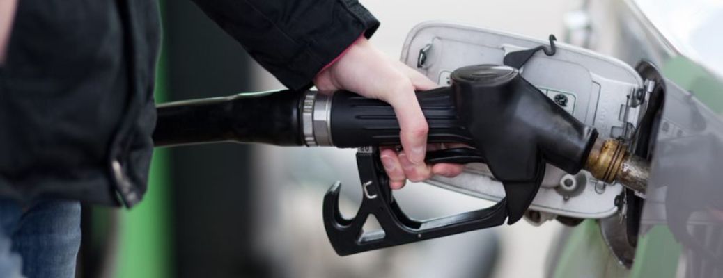 A person filling gas in a car