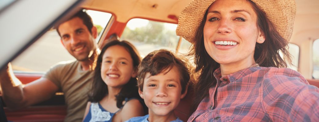 A Family on a road trip and smiling