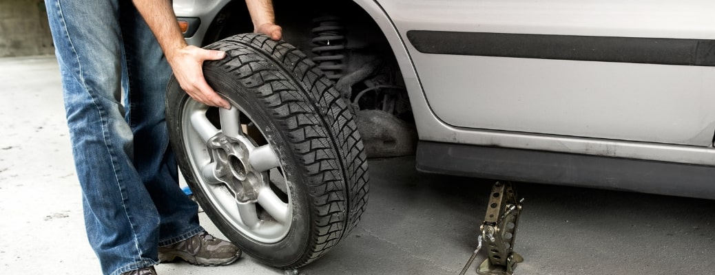 Mechanic checking a vehicle's tire