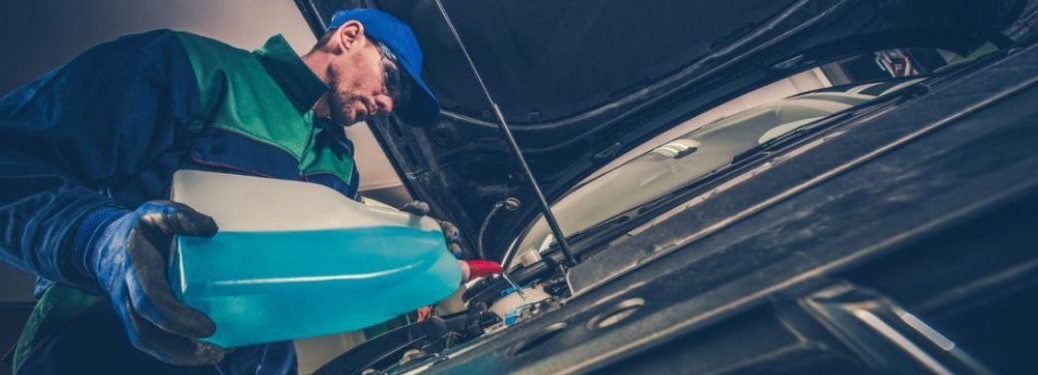 Mechanic pouring transmission fluid