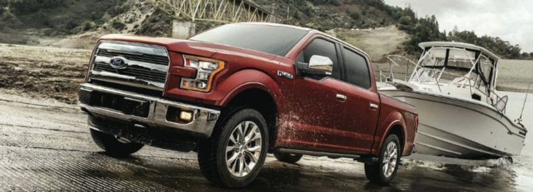 Front three-quarter view of the used Ford F-150 towing a boat