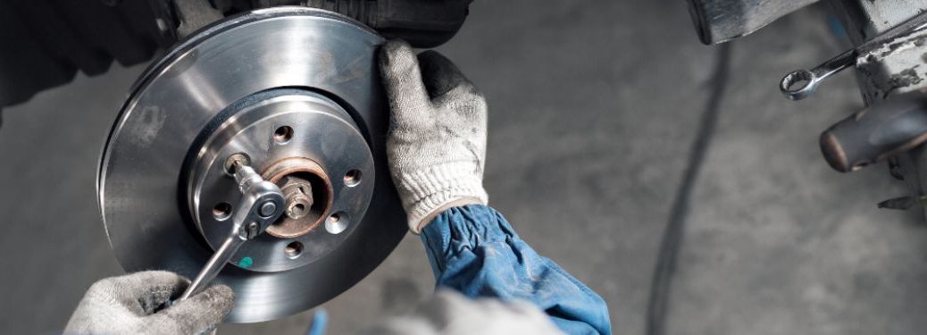 Technician repairing brake of a vehicle