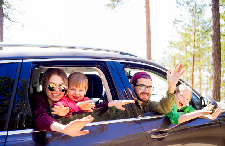 Family sitting inside a car