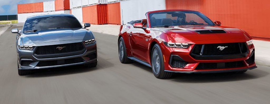 two Ford Mustang models driving together