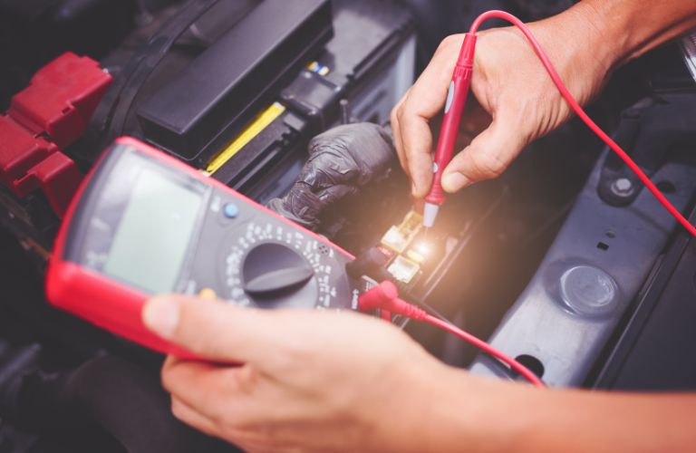 Technician checking a vehicle's battery